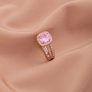 Luxurious rose gold ring with three rows of pavé diamonds and a pink halo zircon stone