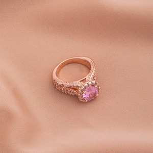 Luxury rose gold ring with pink center stone and triple-layered pavé set cubic zirconia