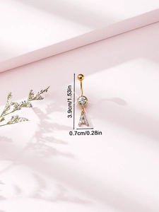 Macro view showing dimensions of golden belly button ring with crystal letter A pendant