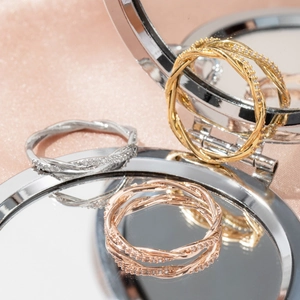 Three-color twisted stackable rings with micro-pave zircons in silver, gold, and rose gold