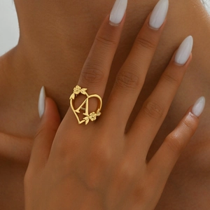 Golden heart-shaped open ring featuring letter A and delicate floral decorations