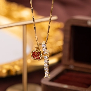 Macro detail of gold double pendant necklace with pave red and white crystals