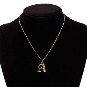 Elegant gold-plated necklace featuring a zircon-encrusted letter A pendant on a black model