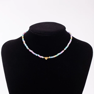 Rainbow macaron beaded necklace with a golden heart pendant featuring initial A