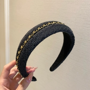 Elegant tweed headband with woven gold chain detail for a stylish hair accessory