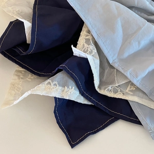 French irregular scrunchie featuring elegant embroidery lace detail and blue fabric textures