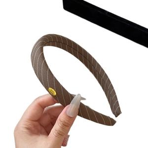 Brown twill sponge headband with handmade metal tag for a vintage high crown look