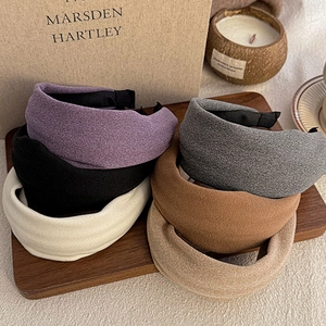 Wide vintage knit velvet padded headbands in assorted colors for women on wood tray