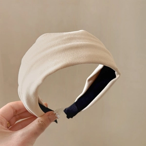 Detail showing wide cream velvet headband texture and non-slip lining for hair styling