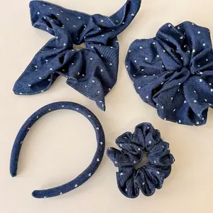 Blue denim hair accessory set with white heart patterns, featuring headband and scrunchies