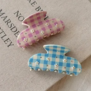 Floral checkered acetate hair claws set with rhinestones for elegant styling