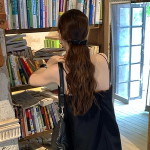 Vintage black velvet banana hair clip with white pearls shown in a ponytail hairstyle