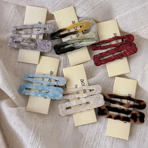 Set of wavy acetate hair clips in vintage tortoiseshell and pastel colors for women