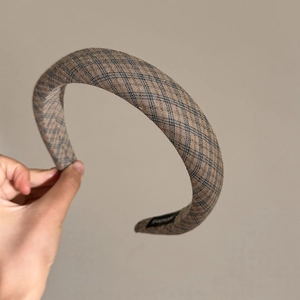 Close-up of retro navy plaid sponge headband with a handmade label inside
