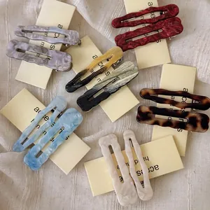 Elegant wavy acetic acid hair clips in various marble patterns for side bangs styling
