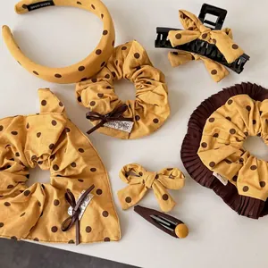 Yellow polka dot hair accessory set including headband and scrunchies with bow details
