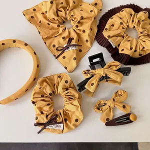 Mustard yellow polka dot hair accessories set including headband and scrunchies