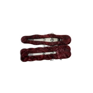 Set of two vintage wavy resin hair clips in dark burgundy marble texture on white background