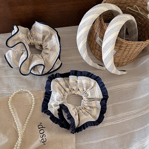 Vintage striped fabric hair scrunchies and wide headbands set in minimalist Japanese style
