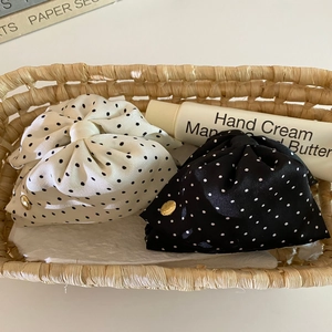 French style polka dot satin drawstring pouches with gold buckle in a woven basket