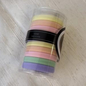 Macaron colored braided hair ties in clear storage bucket for high ponytails