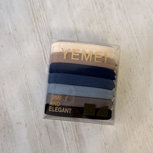 Detailed set of 7 high-elastic hair ties in neutral colors within transparent packaging box