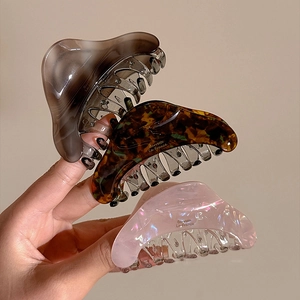 Three elegant acetate shark hair clips in tortoiseshell and marble patterns