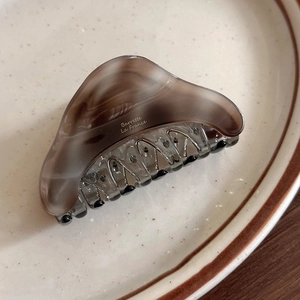 Close-up of tortoise shell hair claw with Barrette La France gold lettering detail