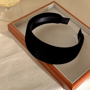 Close-up of black velvet wide padded headband for high cranial top effect on tray