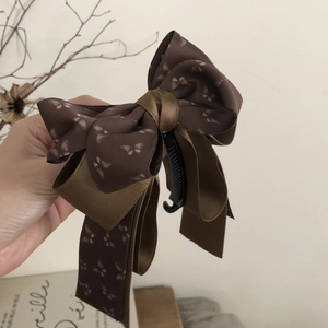 Elegant dark brown ribbon bow banana hair clip with subtle butterfly patterns for women