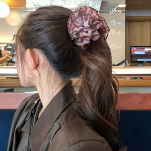 Red plaid large scrunchie worn on high ponytail for elegant hair styling look