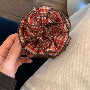 Classic red plaid scrunchie with dark brown wavy edges for high ponytail hairstyle