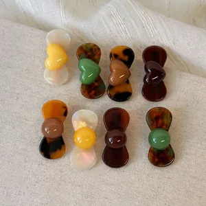 Set of 8 vintage resin hair clips featuring heart and ball shapes in retro colors