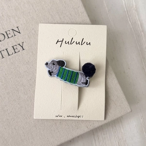 Cute embroidered cartoon squirrel hair clip with blue striped sweater and plush tail detail