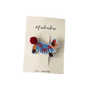 Cute embroidered dachshund dog hair clip with red pom-pom and blue striped sweater detail