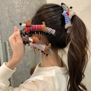 Cute cartoon dachshund plush hair claw clip for high ponytail styling on brunette model