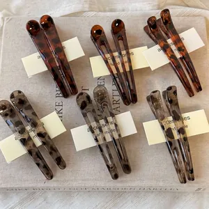 Set of 12 large leopard print duckbill hair clips in brown and grey tortoiseshell resin