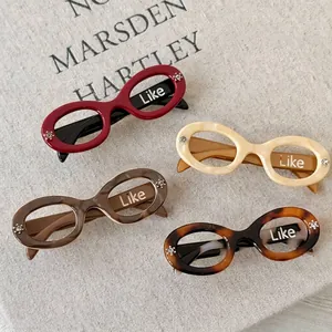 Retro sunglasses-shaped acetate hair clips with rhinestones in various vintage colors