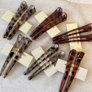 Elegant leopard print and tortoiseshell acrylic hair clips set for women on display
