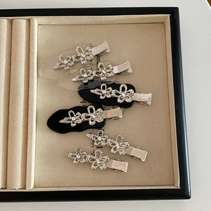 6-piece set of silver metal flower hair clips with rhinestones for women on a tray