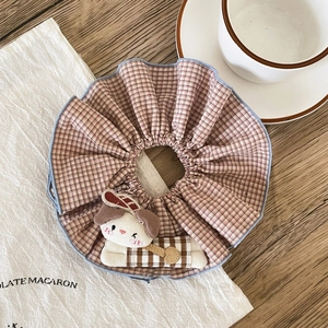 Detail of checkered plaid scrunchie featuring a cute 3D cartoon puppy plush doll