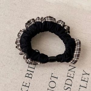 Retro plaid patchwork scrunchie with black fabric and decorative plastic buckle detail