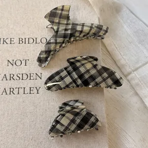 Three-piece checkered acetate hair claw clips set in black and white pattern