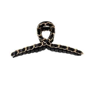 Classic black hair claw clip with golden metal chain and woven leather detail