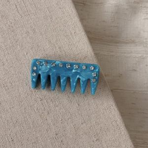 Vintage blue acetate hair comb with marble texture and sparkling rhinestone inlay