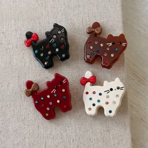Acetate cat hair clips with colorful rhinestones and bows in four vibrant colors