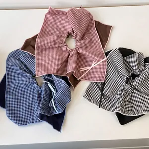 Three plaid doll collars with bow ties in pink, blue, and black for school style outfits