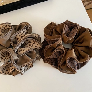Satin leopard print hair scrunchies in champagne and brown colors with layered design