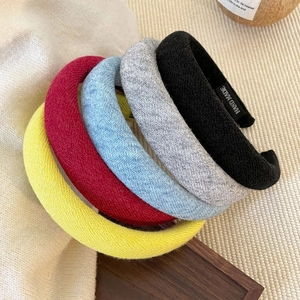 Five-piece set of thick knitted headbands in assorted colors with a handmade label