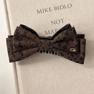 Brown leopard print bow banana hair clip with elegant golden logo detail for women